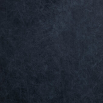 Dark blue textured surface with mottled effect, displaying irregular lines and a matte finish, resembling aged leather or paper grain.